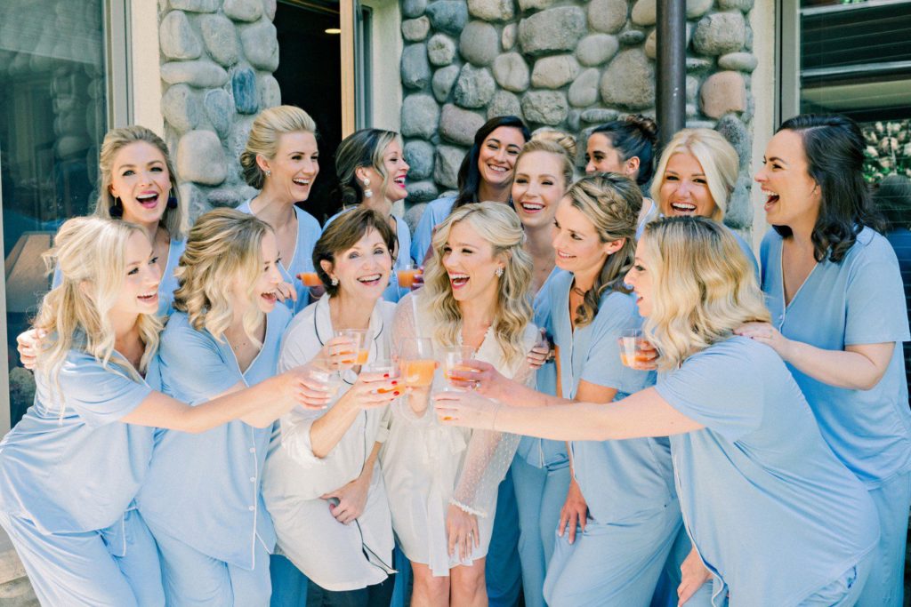 Bride and Bridesmaids toasting champagne while getting ready