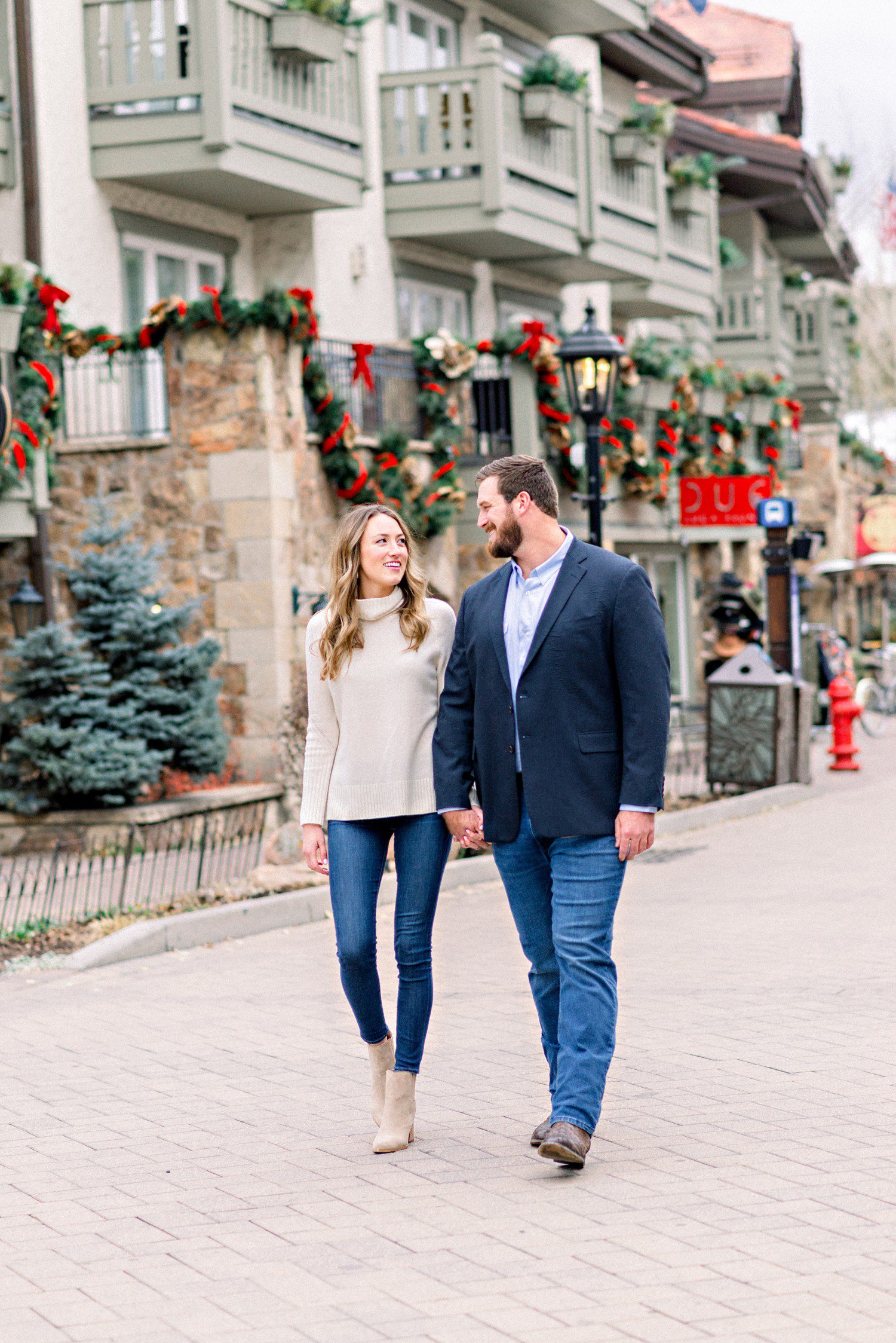 Couple walking for Vail Village engagement session in winter