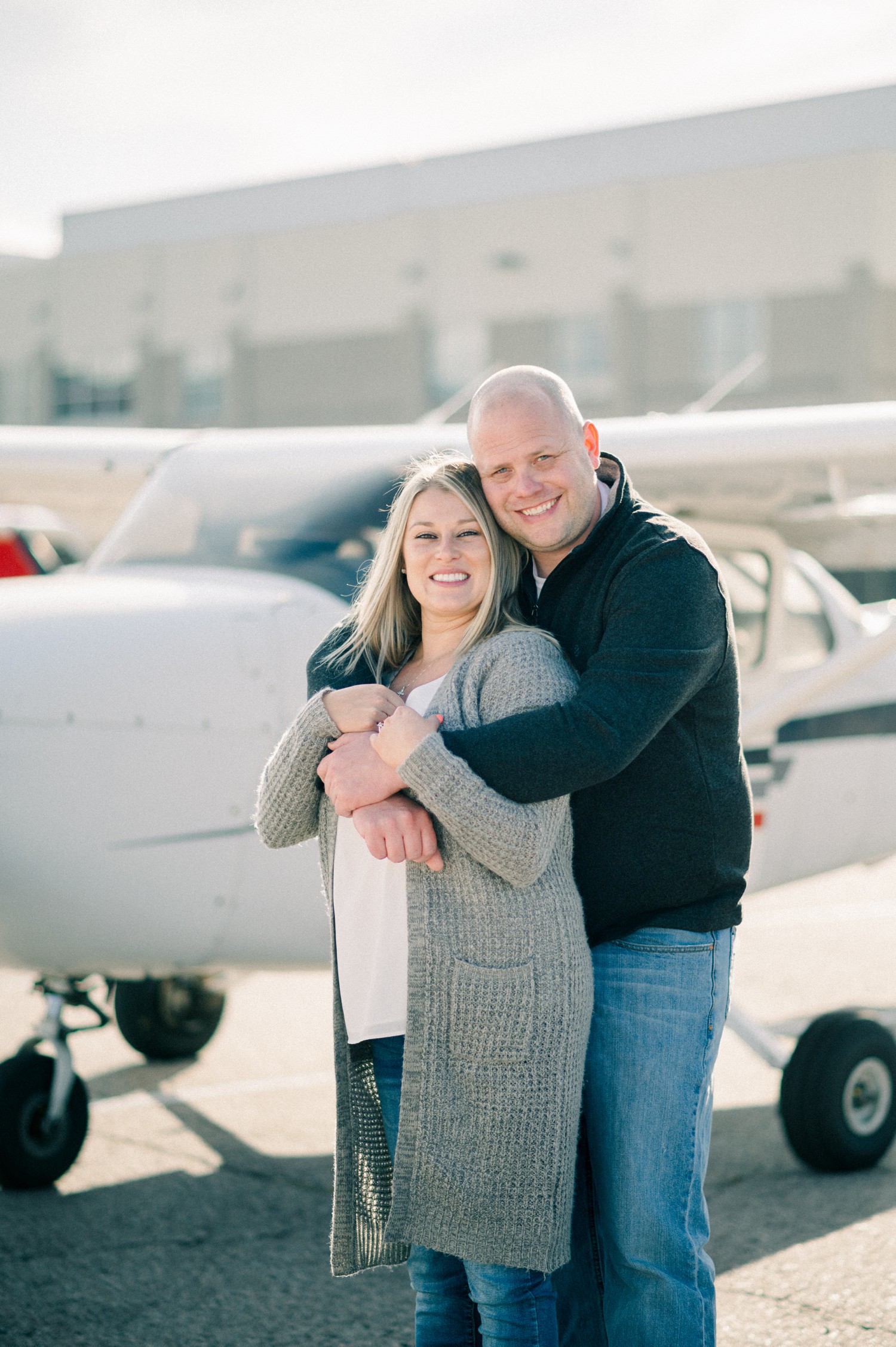 Couple engagement photos in front of airplane in Denver.