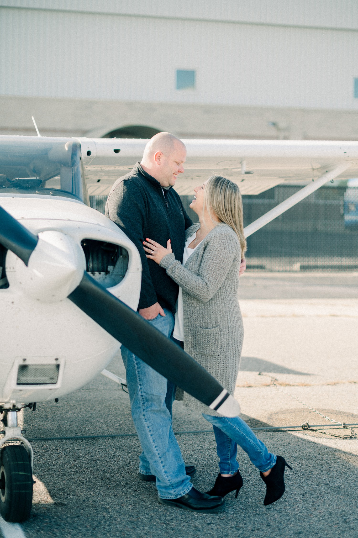 Engagement photos in front of airplane in Denver.