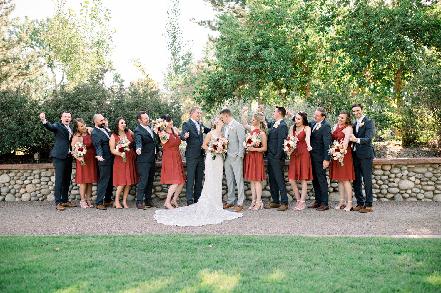 Bride and groom kissing during wedding party photos.