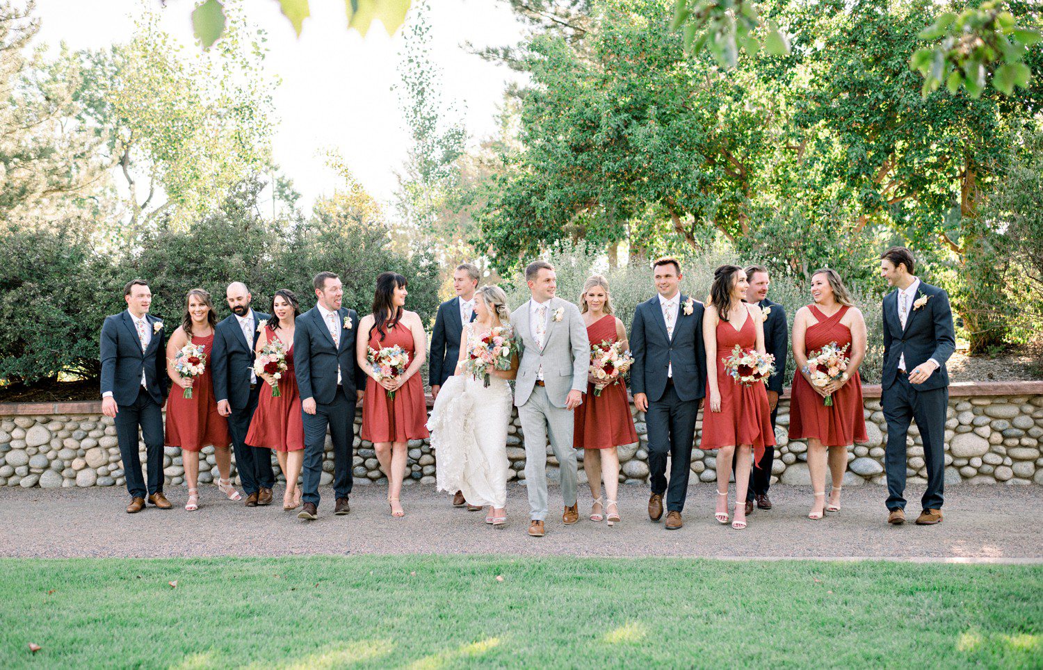 Bride and groom walking with wedding party at Hudson Gardens