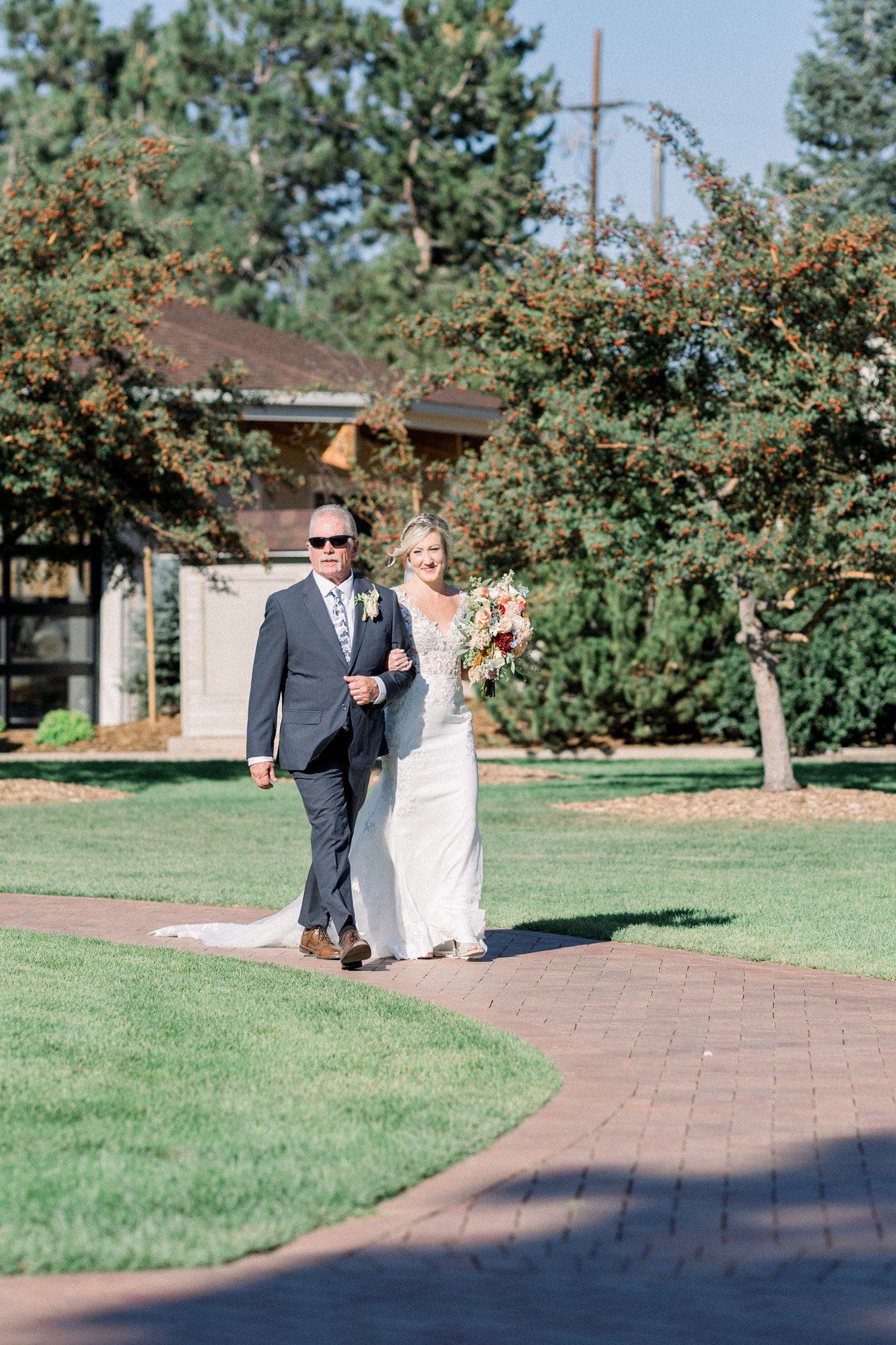 Bride and walking down the aisle during ceremony at Hudson Gardens in Denver.