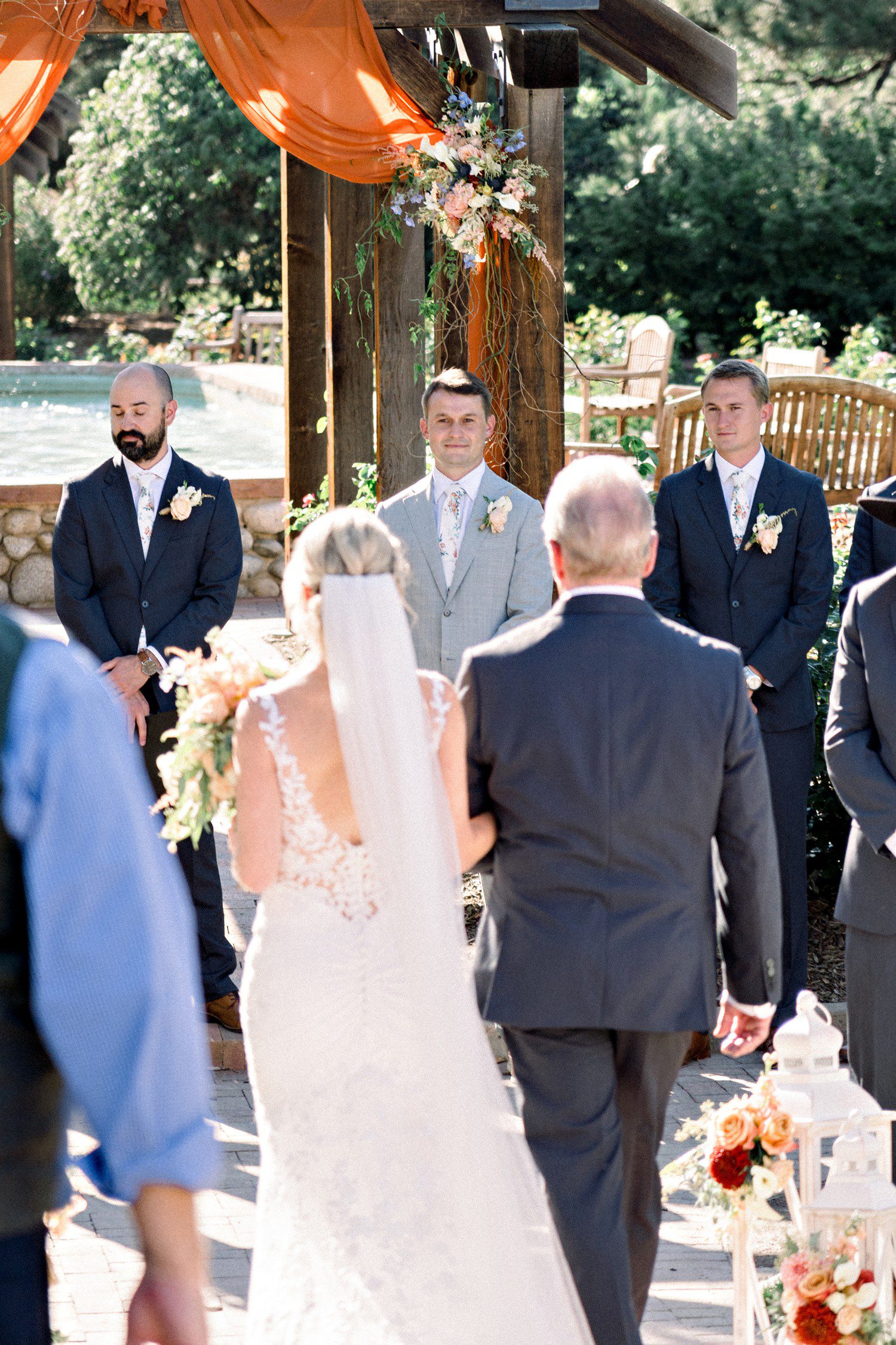 Groom watching bride walk down the aisle at Hudson Gardens.