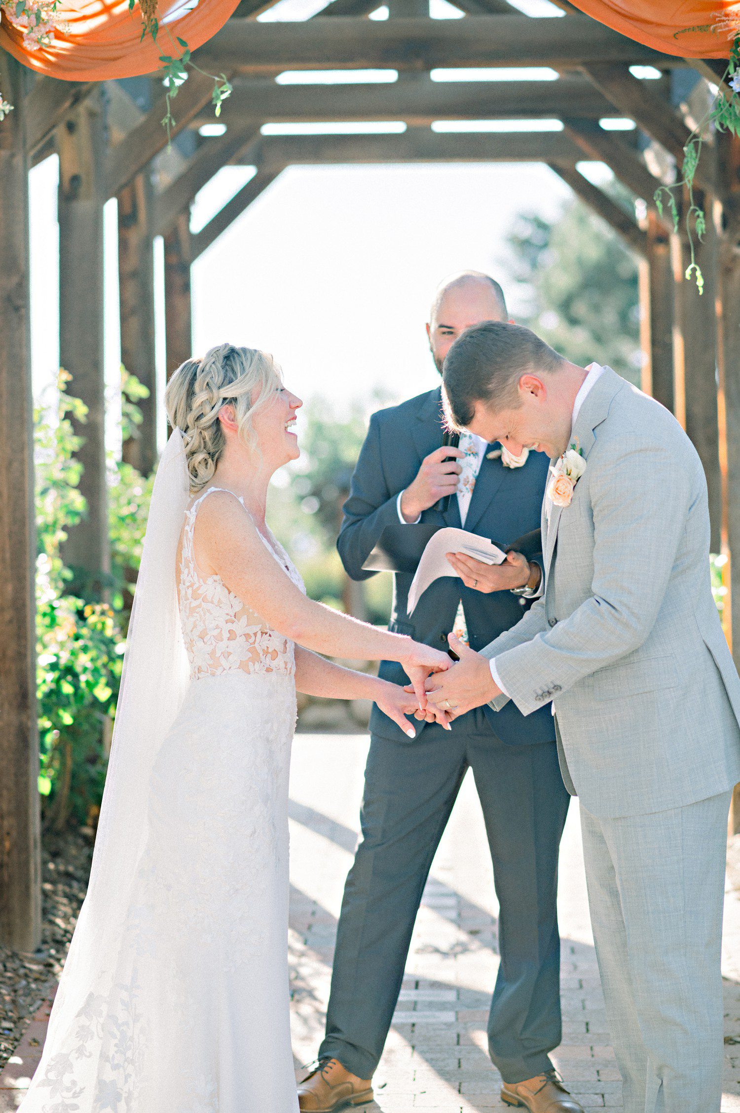 Bride and groom laughing during wedding ceremony at Hudson Gardens.