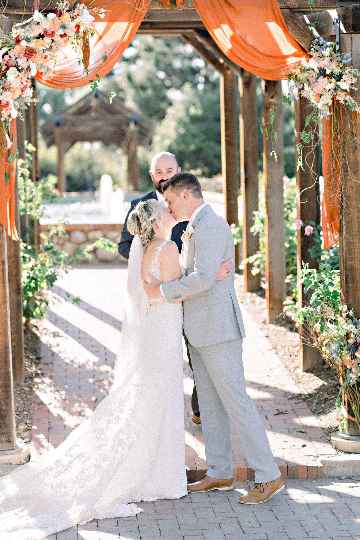 Wedding ceremony kiss at Hudson Gardens in Denver.