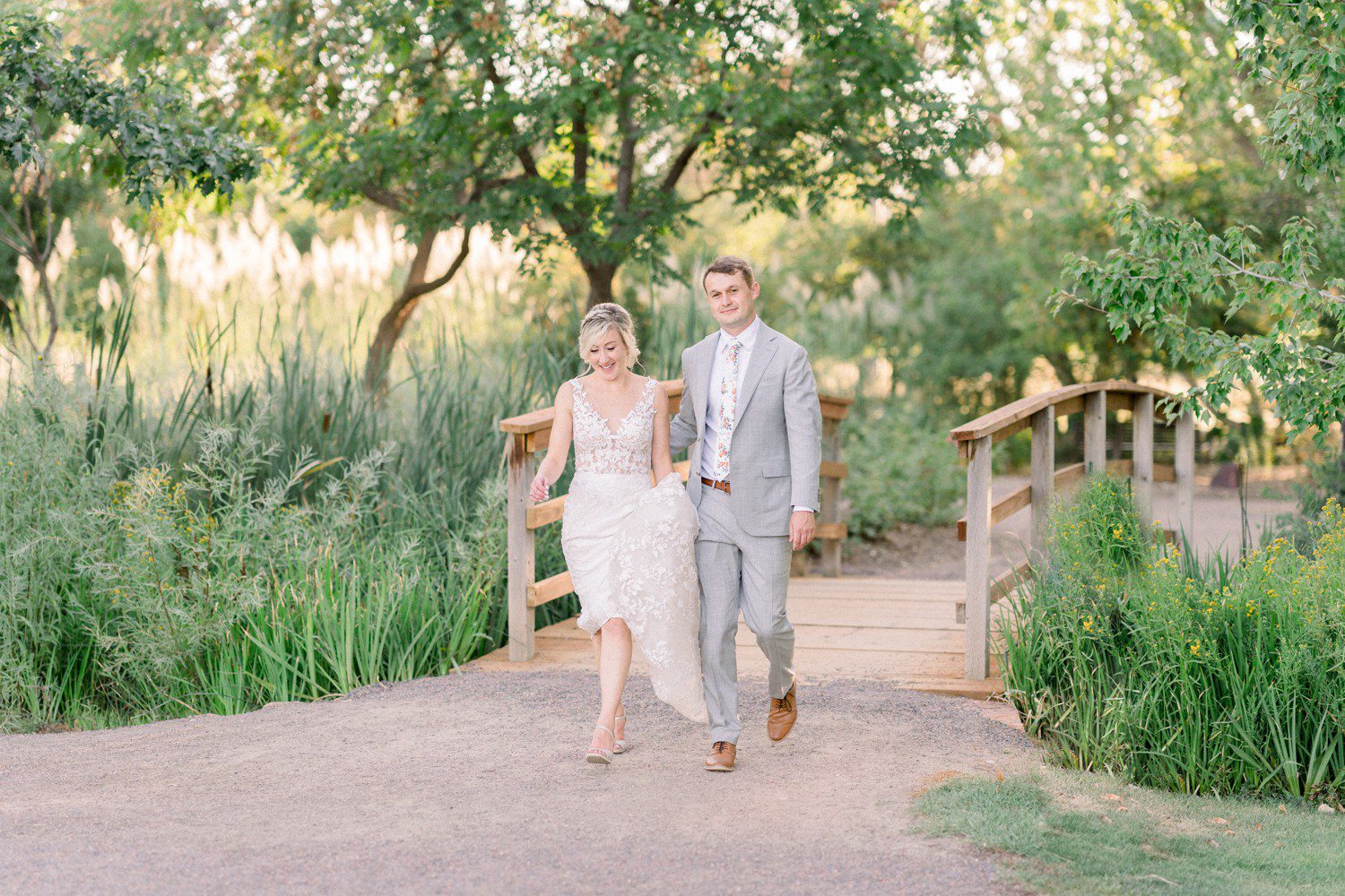 Bride and groom walking to reception at Hudson Gardens.