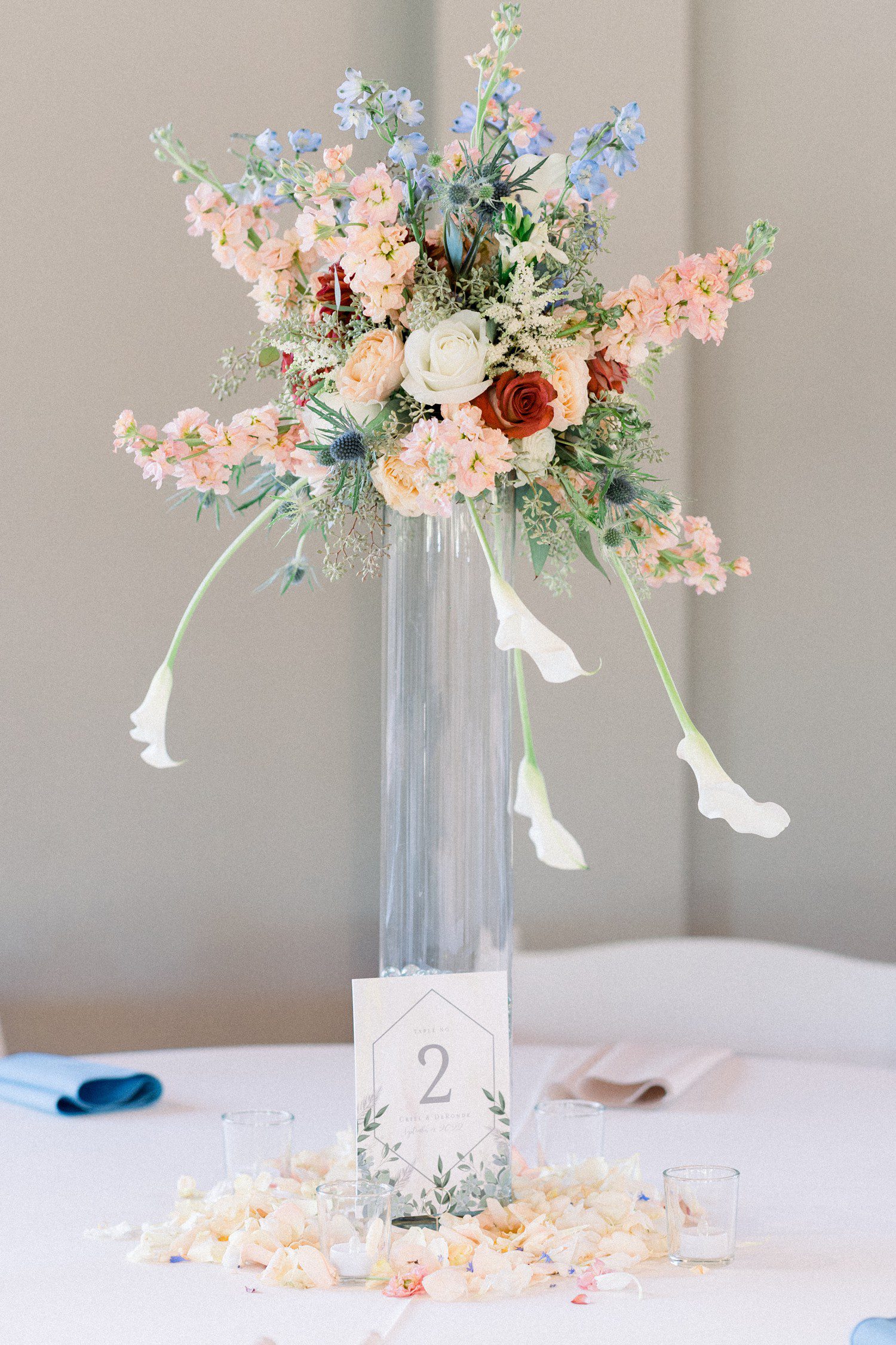 Wedding reception table decor with colorful bouquets.