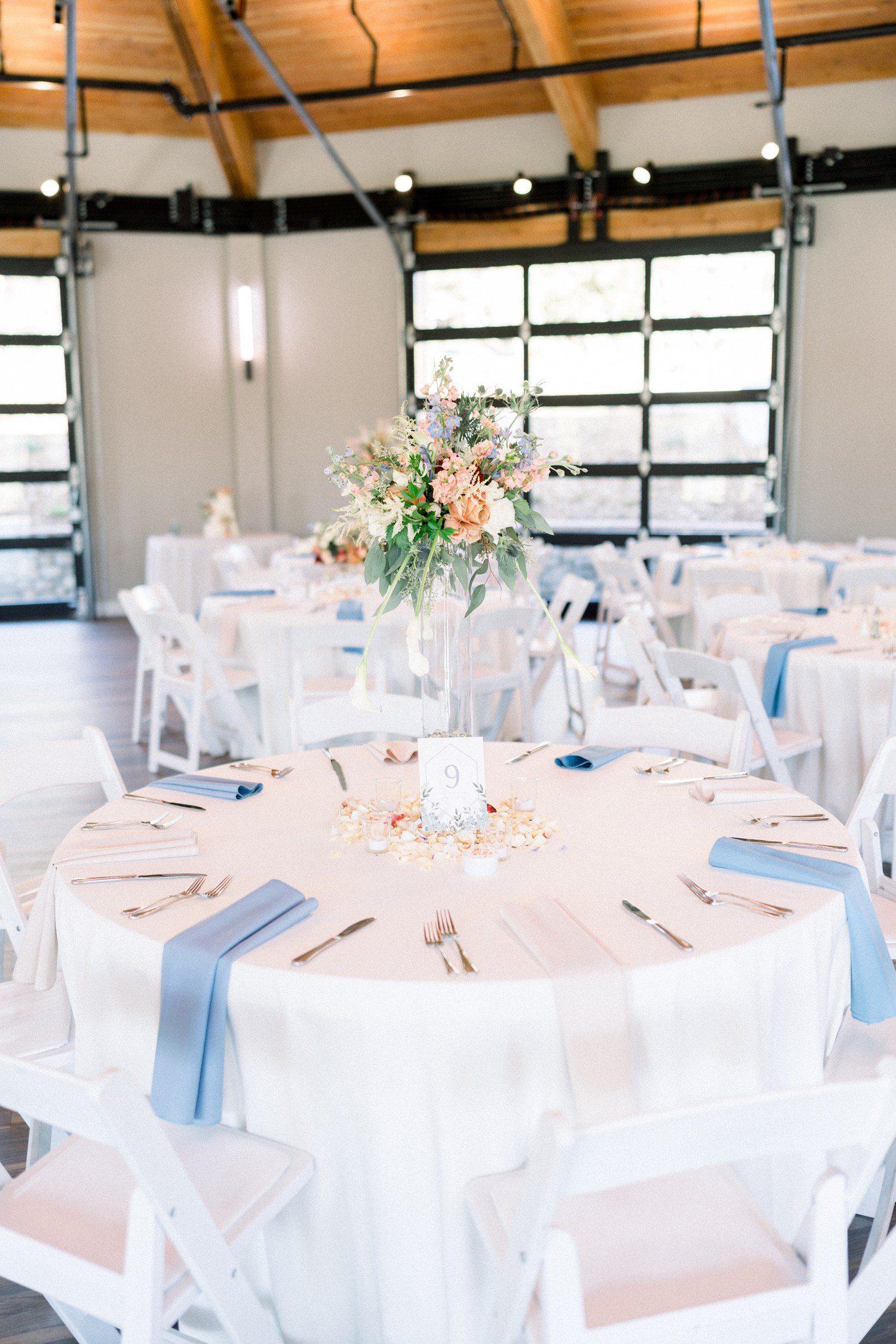 Hudson Gardens wedding reception in the Bloom Room with colorful bouquets on tables.