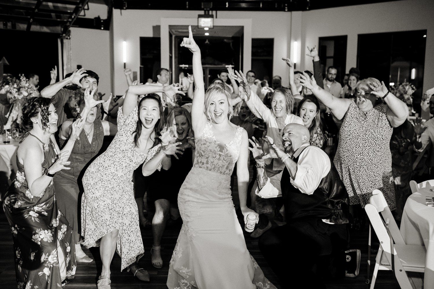 Bride dancing with wedding guests at reception.