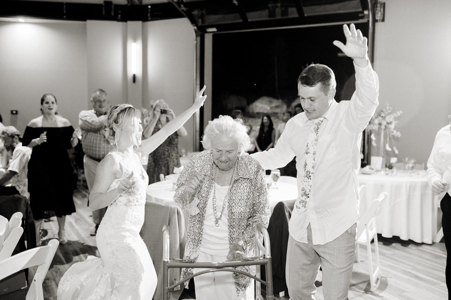 Bride and Groom dancing with family during reception.