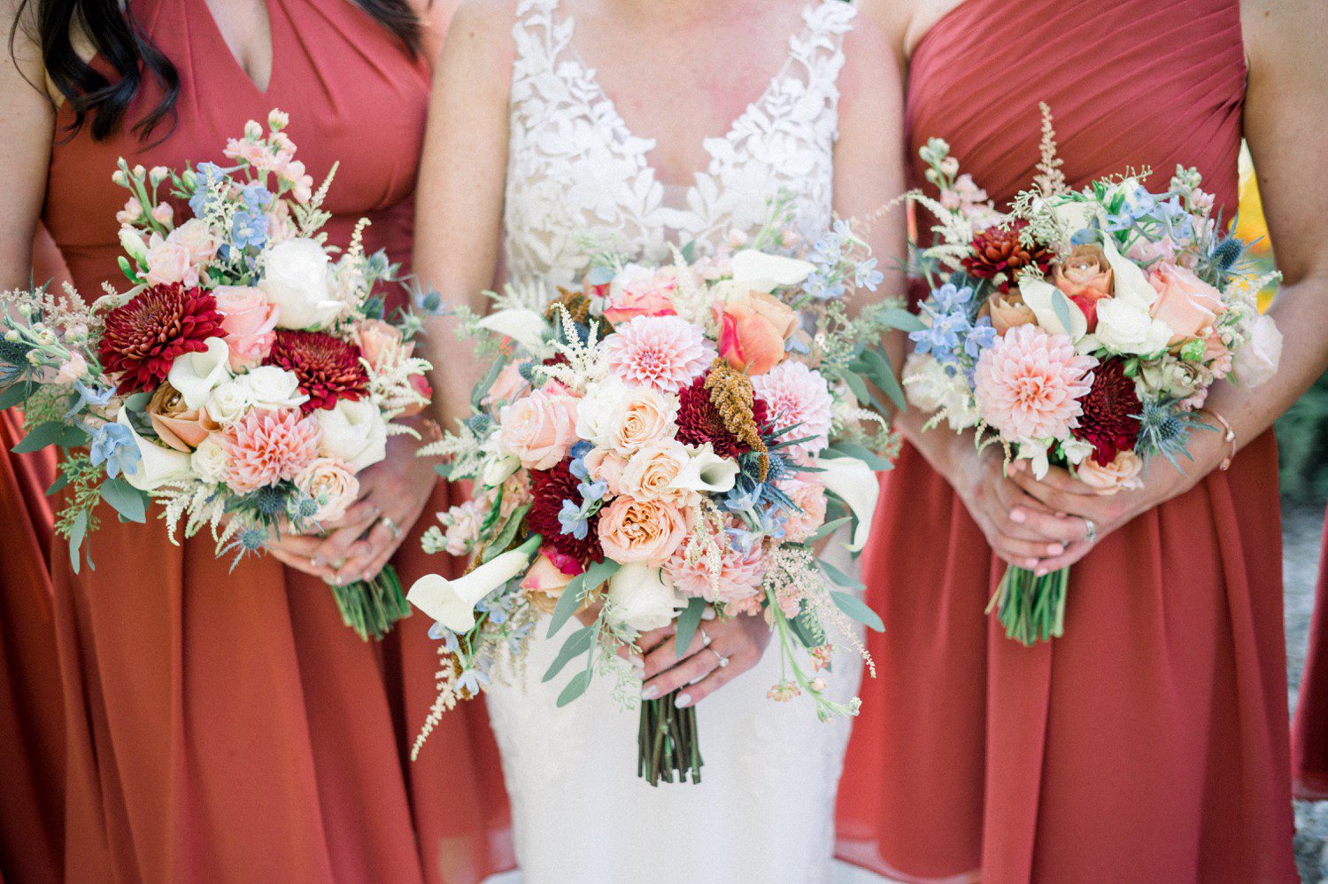 Terracotta bridesmaid dresses with colorful bouquets.