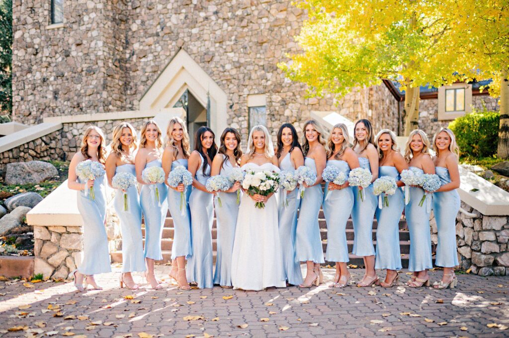 Bridesmaid photos outside of The Chapel at Beaver Creek with  bridesmaids in light blue dresses. 