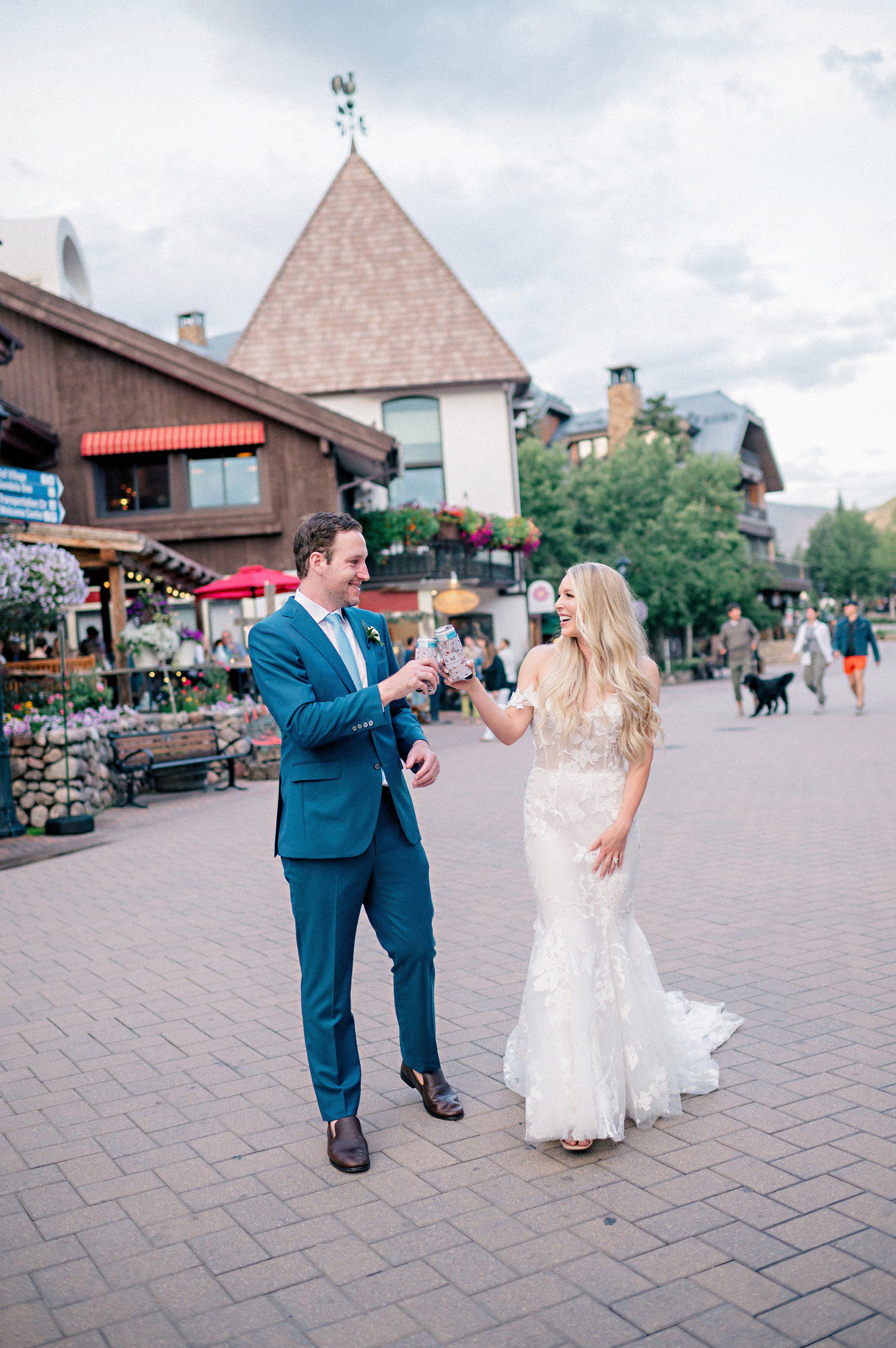 Bride and groom walking in Vail Village for wedding photos before reception at The Sebastian Hotel. 