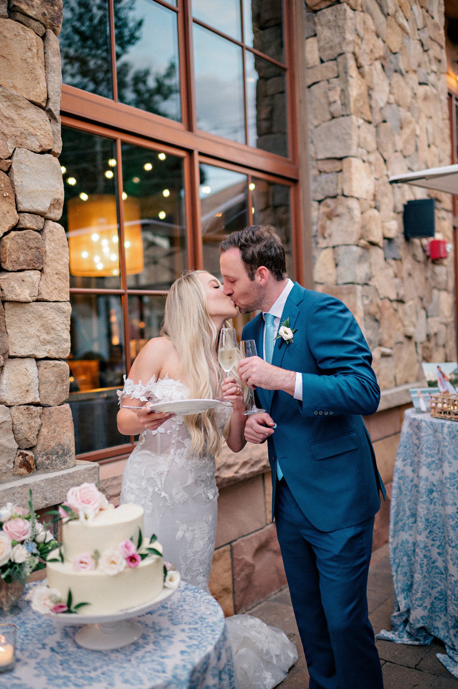 Bride and groom cutting cake during wedding reception at The Sebastian Hotel in Vail Colorado. 