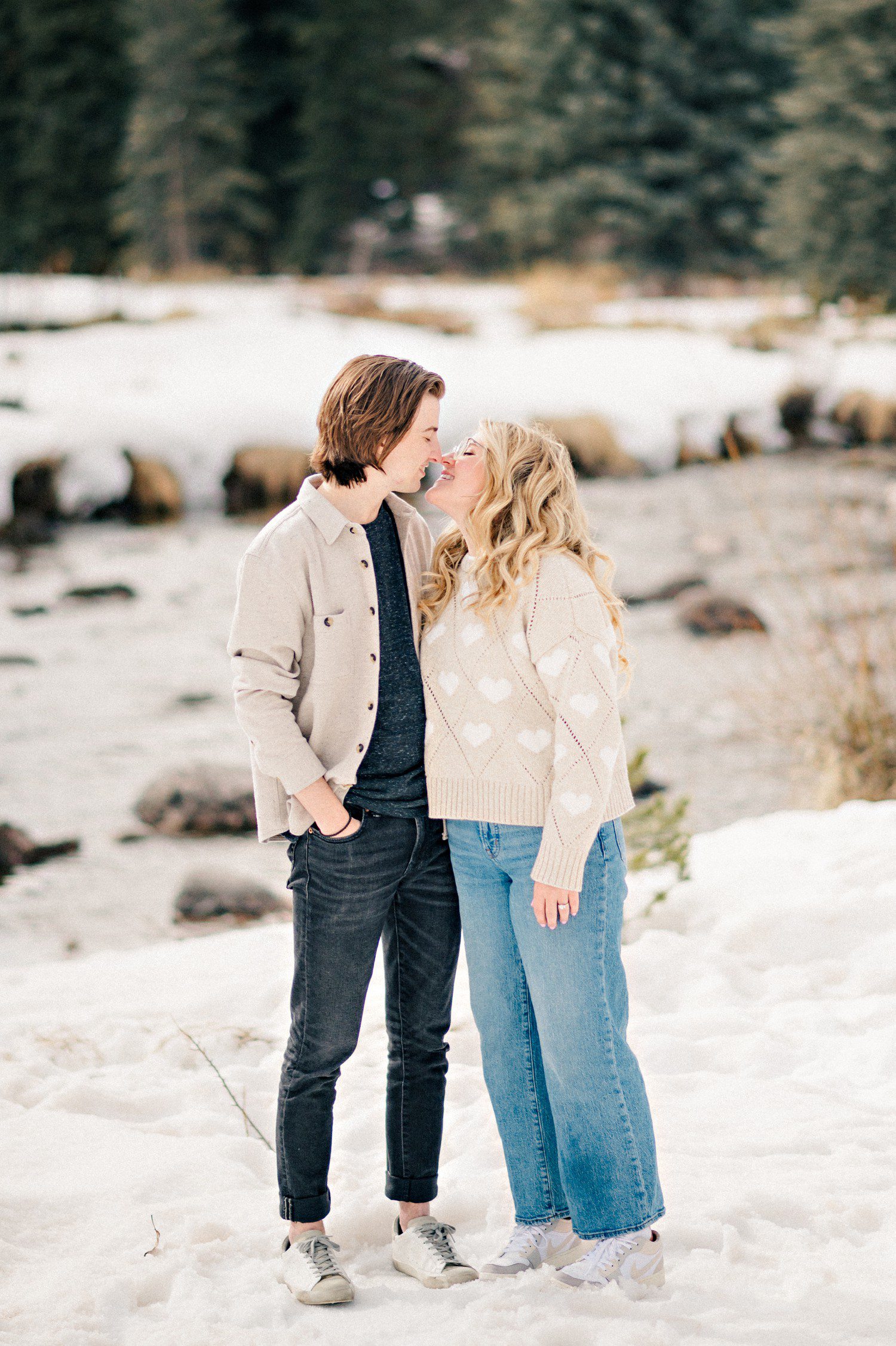 Snowy Engagement Photos in Vail Village by Gore Creek. 